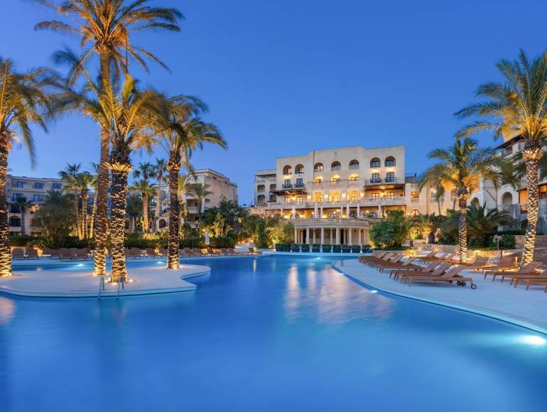 Kempinski San Lawrenz pool at dusk